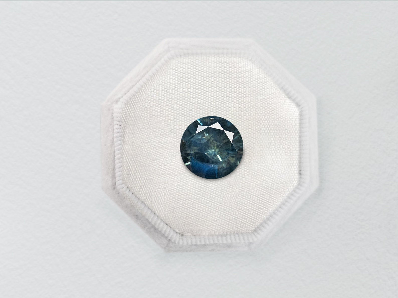 0.73ct Blue Teal Nebula Round Brilliant Sapphire - Lelya - bespoke engagement and wedding rings made in Scotland, UK