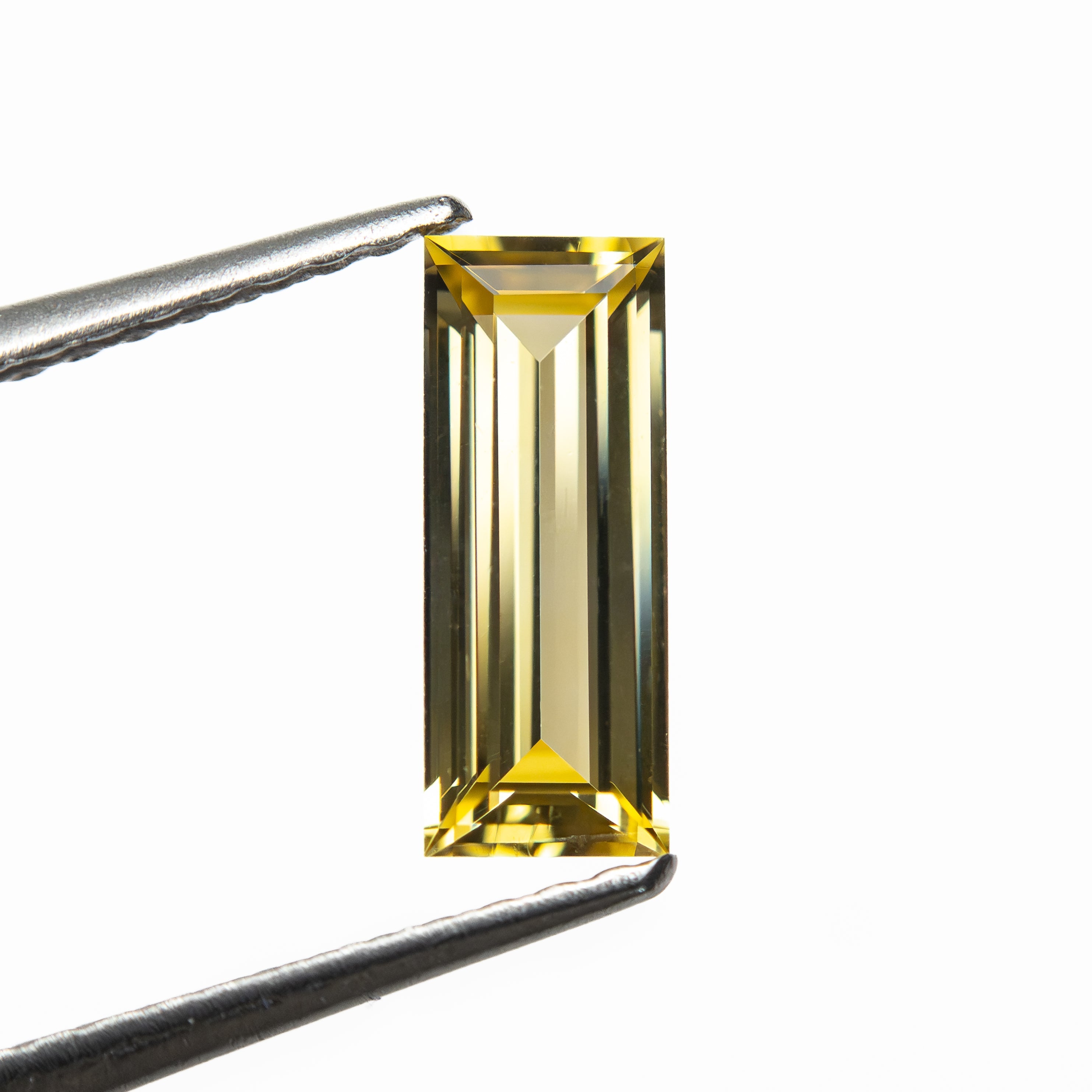 0.79ct 9.06x3.55x2.21mm Baguette Step Cut Sapphire 27719-05 - Lelya - bespoke engagement and wedding rings made in Scotland, UK