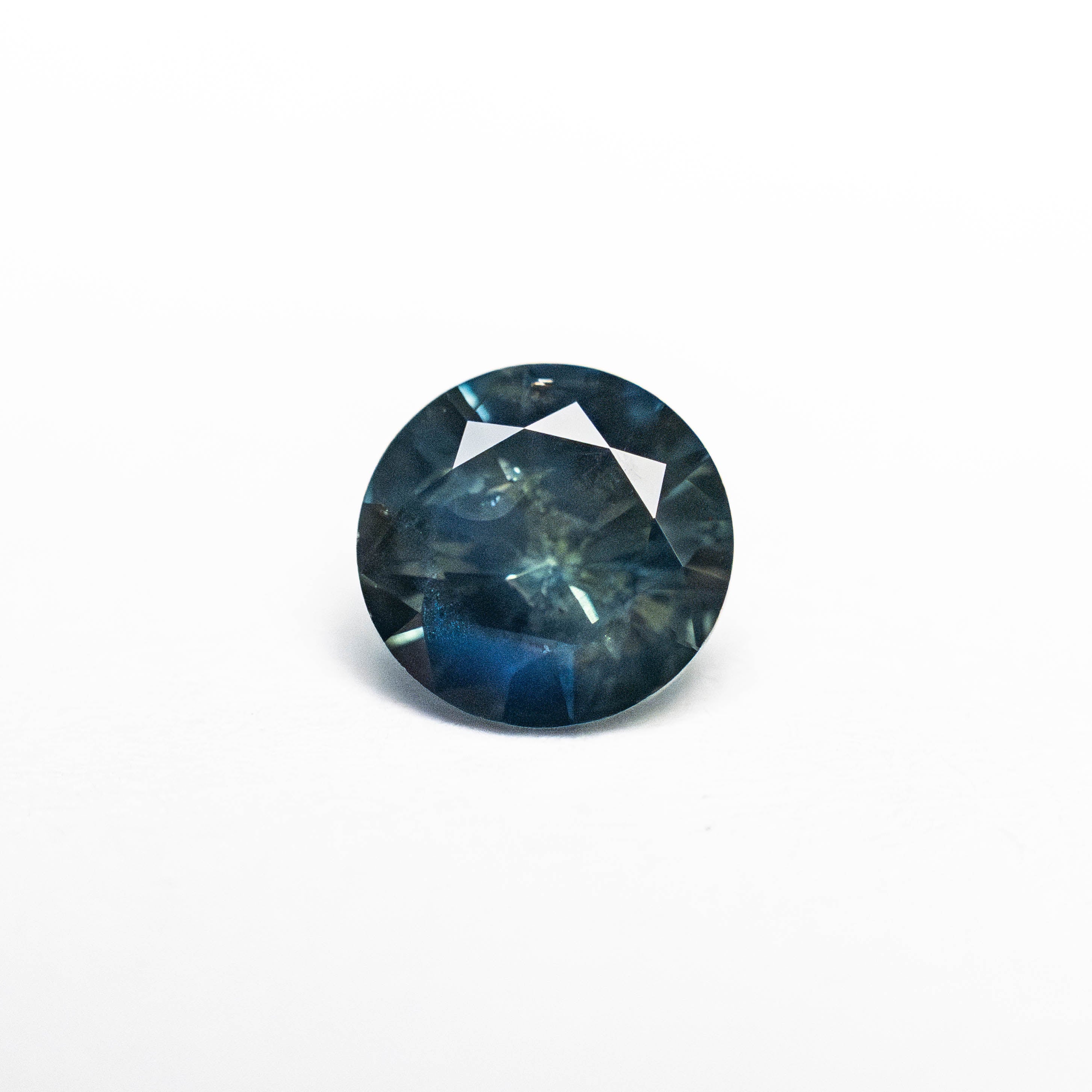 0.73ct Blue Teal Nebula Round Brilliant Sapphire - Lelya - bespoke engagement and wedding rings made in Scotland, UK